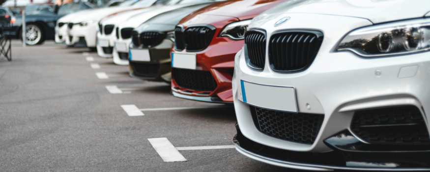 Reihe geparkter Autos auf einem Parkplatz – symbolisch für Dienstwagen. Das Bild steht im Kontext eines Blogbeitrags zur Privatnutzung von Geschäftsfahrzeugen und den steuerlichen Nachweispflichten.
